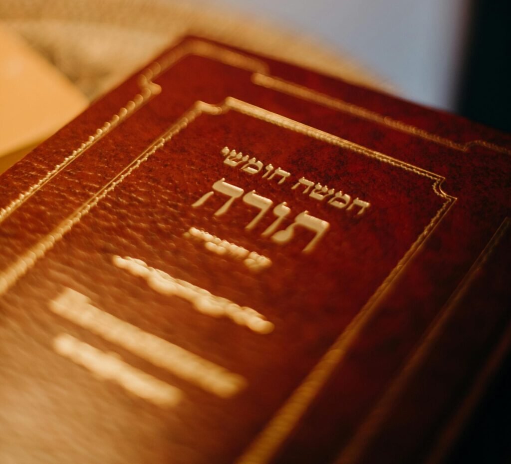A close-up view of a Torah book with Hebrew text, symbolizing Jewish tradition and spirituality.